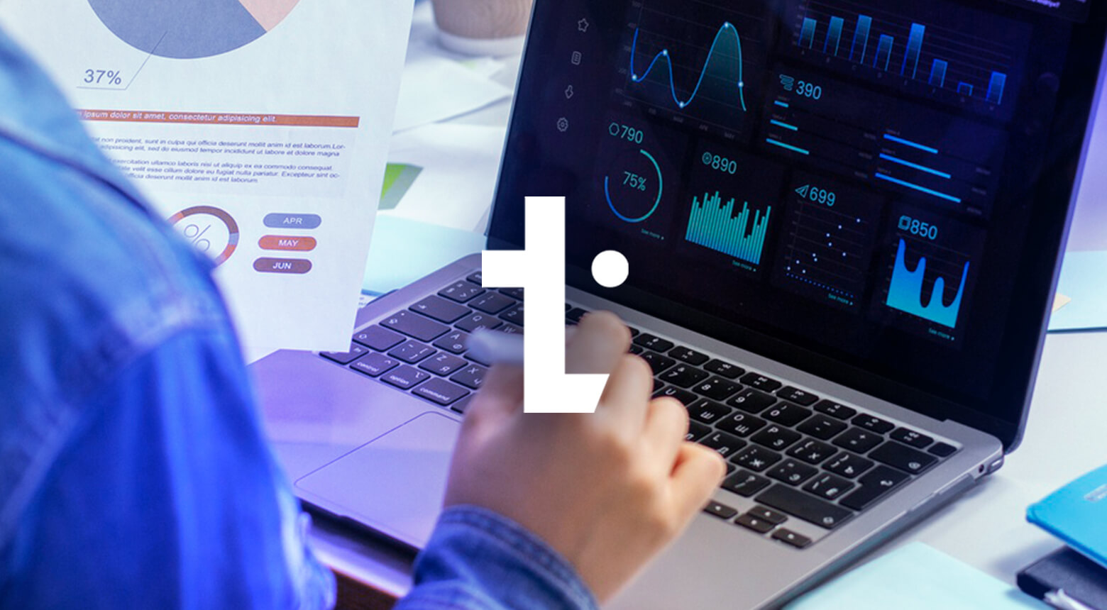 A graphic featuring the TechMarketView 'T' in white on a background of a person reviewing data at their laptop.