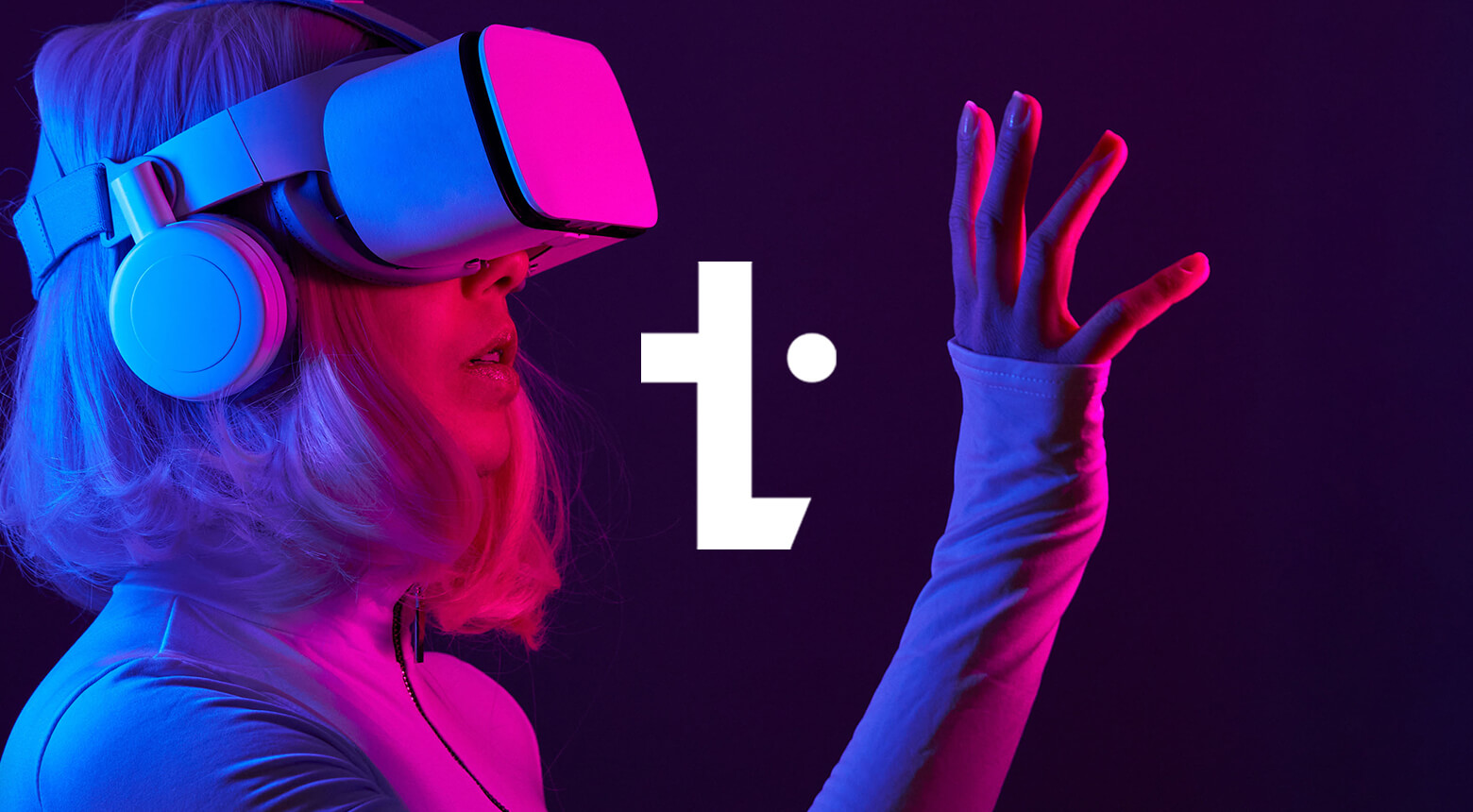 An image of a woman lit in red and blue lights, using a virtual reality headset. There is a text overlay, announcing "UKHotViews".